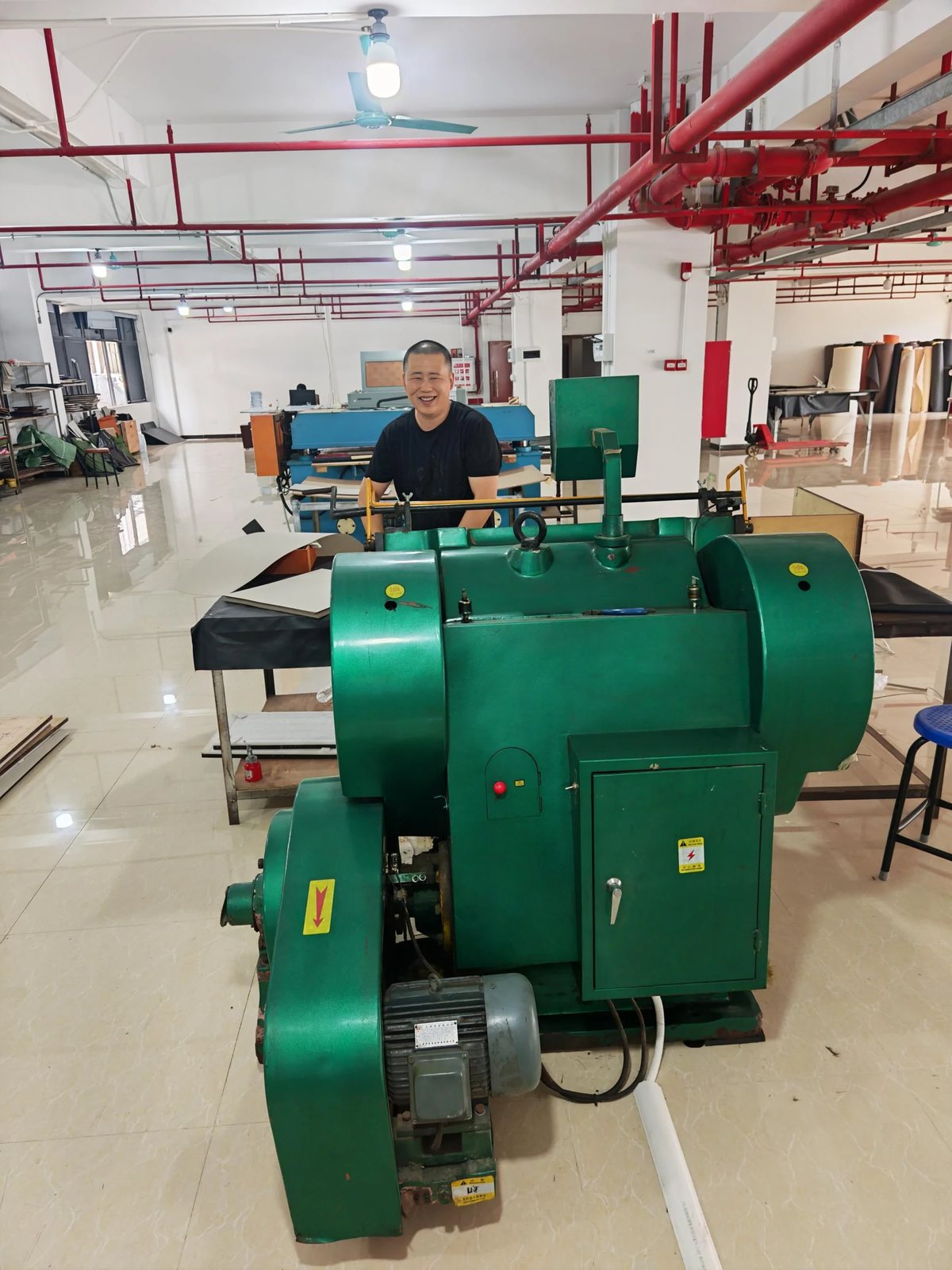Die-cutting press used to cut board and sheet panels to a repeatable outline.