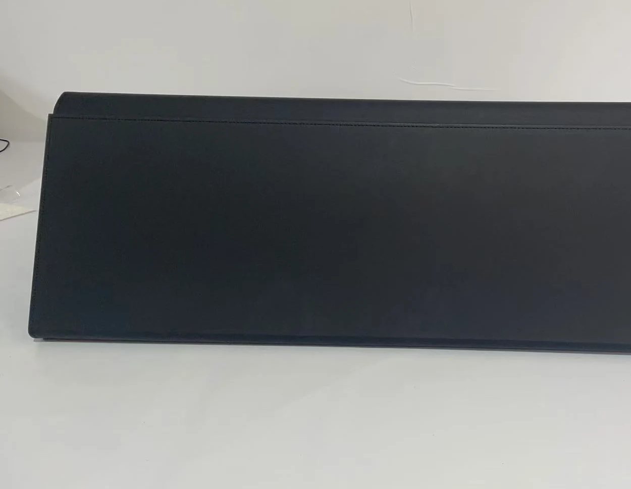 Assembled folding storage box sample with the lid closed and a stitched leather-look surface.