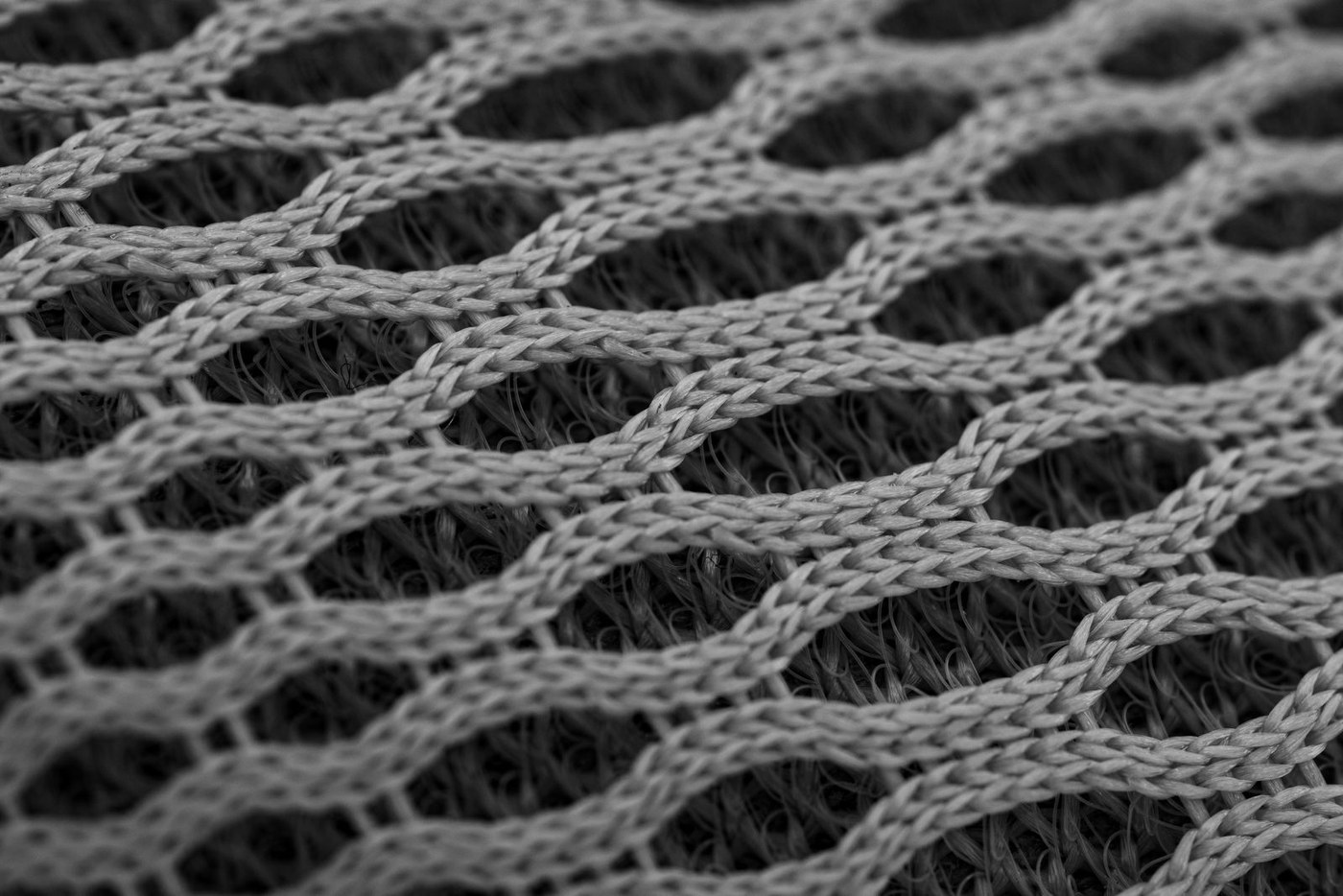 Close-up of grey open-cell mesh fabric used for ventilation panels.